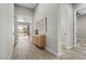 Bright foyer with wood-look tile floors and a mid-century modern console table at 4096 E Alamosa Pl, Chandler, AZ 85249