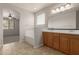 Bathroom featuring a double sink vanity, a soaking tub, tile flooring and window at 42374 W Avella Dr, Maricopa, AZ 85138