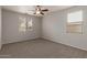 Bedroom with neutral walls, new carpet, and lots of natural light from two windows at 42374 W Avella Dr, Maricopa, AZ 85138