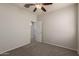 Bedroom showcasing neutral carpet, a ceiling fan, and a standard closet door at 42374 W Avella Dr, Maricopa, AZ 85138