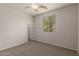 Bedroom with neutral carpet, ceiling fan and window at 42374 W Avella Dr, Maricopa, AZ 85138