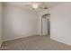 Bedroom featuring neutral carpet, ceiling fan and closet at 42374 W Avella Dr, Maricopa, AZ 85138