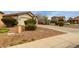 Single-story home with well-maintained desert landscaping and a long driveway at 42374 W Avella Dr, Maricopa, AZ 85138