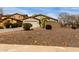 Single-story house showcasing desert landscaping, an attached two-car garage, and a block wall at 42374 W Avella Dr, Maricopa, AZ 85138