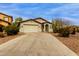 Charming single-story home featuring a two-car garage and desert landscaping at 42374 W Avella Dr, Maricopa, AZ 85138
