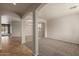 Open-concept living space with archways, tile floors, and carpet at 42374 W Avella Dr, Maricopa, AZ 85138