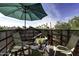 Private rooftop deck with city views, chairs, a table, and a shade umbrella at 531 E Lynwood St, Phoenix, AZ 85004