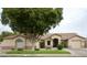 One-story house with a large tree and green lawn at 5414 E Glade Ave, Mesa, AZ 85206