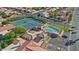 Aerial view of community pool, tennis courts, and parking at 563 W Champagne Dr, Chandler, AZ 85248