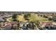 Aerial view of houses near a green golf course at 563 W Champagne Dr, Chandler, AZ 85248