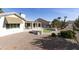 Landscaped backyard with covered patio and putting green at 563 W Champagne Dr, Chandler, AZ 85248