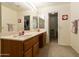 Bathroom with double sinks, large mirror, and walk-in shower at 563 W Champagne Dr, Chandler, AZ 85248