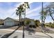 Single story home with two palm trees and landscaped yard at 563 W Champagne Dr, Chandler, AZ 85248