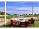 Fire pit area with red chairs and a pond view at 563 W Champagne Dr, Chandler, AZ 85248