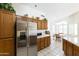 Kitchen with stainless steel refrigerator and wood cabinets at 563 W Champagne Dr, Chandler, AZ 85248