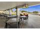 Outdoor patio area with several tables and chairs and TVs overlooking a golf course at 563 W Champagne Dr, Chandler, AZ 85248
