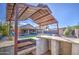 Outdoor kitchen with built-in grill and bar seating at 7318 W Jones Ave, Phoenix, AZ 85043