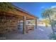Backyard patio with stone wall and wooden bench at 7318 W Jones Ave, Phoenix, AZ 85043