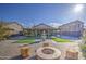Artificial turf, fire pit and fountain in backyard at 7318 W Jones Ave, Phoenix, AZ 85043