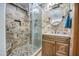 Clean bathroom featuring a walk-in shower and wood vanity at 7318 W Jones Ave, Phoenix, AZ 85043
