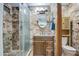 Updated bathroom with walk-in shower and wood vanity at 7318 W Jones Ave, Phoenix, AZ 85043
