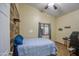 Cozy bedroom with wood-like accent wall and tiled floor at 7318 W Jones Ave, Phoenix, AZ 85043