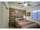 Spacious bedroom with wood-like accent wall and tiled floor at 7318 W Jones Ave, Phoenix, AZ 85043
