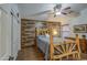 Cozy bedroom with wood-look walls and ceiling fan at 7318 W Jones Ave, Phoenix, AZ 85043