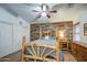 Serene bedroom with wood-look walls and ceiling fan at 7318 W Jones Ave, Phoenix, AZ 85043