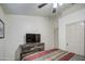Bright bedroom with wood-like accent wall and tiled floor at 7318 W Jones Ave, Phoenix, AZ 85043