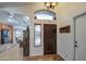 Inviting entryway with a rustic wood door and tiled flooring at 7318 W Jones Ave, Phoenix, AZ 85043