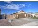 House exterior with a large driveway, double-door garage, and gated entry at 7318 W Jones Ave, Phoenix, AZ 85043