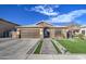 Single-story home with stone accents, landscaped yard, and a two-car garage at 7318 W Jones Ave, Phoenix, AZ 85043
