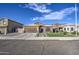Single-story home with stone exterior, landscaping, and a paved driveway at 7318 W Jones Ave, Phoenix, AZ 85043