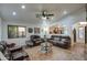 Living room with a stone fireplace, leather couches, and access to backyard at 7318 W Jones Ave, Phoenix, AZ 85043