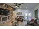Spacious living room featuring a stone fireplace, leather furniture, and high ceilings at 7318 W Jones Ave, Phoenix, AZ 85043