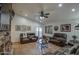 Living room with a stone fireplace, leather couches, and access to a back patio at 7318 W Jones Ave, Phoenix, AZ 85043