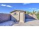 Tan colored storage shed in backyard at 7318 W Jones Ave, Phoenix, AZ 85043