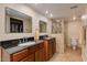 Bathroom with double sinks, granite counters, and shower at 7785 E Luke Ln, Scottsdale, AZ 85250