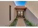 Brick pathway leads to double doors entry with tile flooring at 7785 E Luke Ln, Scottsdale, AZ 85250