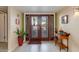 Interior entryway with double doors, tile floor, and small table at 7785 E Luke Ln, Scottsdale, AZ 85250