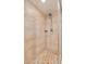 Walk-in shower with stone tile and handheld shower head at 7785 E Luke Ln, Scottsdale, AZ 85250