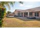 Spacious backyard with covered patio, hot tub, and grassy area at 7869 W Kristal Way, Glendale, AZ 85308