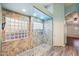 Primary bathroom with large walk-in shower and stone tile at 7869 W Kristal Way, Glendale, AZ 85308