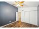 Bedroom with wood-look floors, ceiling fan and double door closet at 7869 W Kristal Way, Glendale, AZ 85308