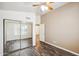Bedroom with mirrored closet doors and wood-look floors at 7869 W Kristal Way, Glendale, AZ 85308