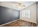 Bright bedroom with wood-look floors and ceiling fan at 7869 W Kristal Way, Glendale, AZ 85308