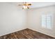 Bright bedroom with wood-look floors and plantation shutters at 7869 W Kristal Way, Glendale, AZ 85308