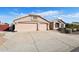 Two-car garage with driveway and desert landscaping at 7869 W Kristal Way, Glendale, AZ 85308