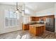 Kitchen with island, stainless steel appliances, and wood cabinets at 7869 W Kristal Way, Glendale, AZ 85308